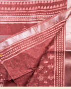 A folded Pure Lenin cotton saree in Onion Pink, showcasing its woven block patterns and metallic borders, with a brand logo banner at the bottom.